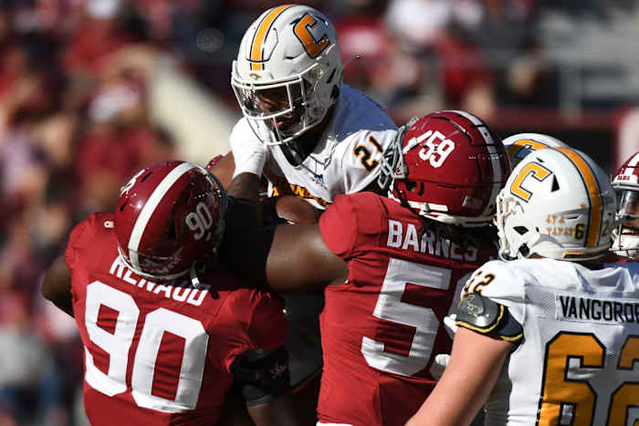Nov 18, 2023; Tuscaloosa, Alabama, USA; Alabama Crimson Tide defensive lineman Jordan Renaud (90) and defensive lineman Anquin Barnes Jr. (59) stop Chattanooga Mocs running back Chris Houston (21) at Bryant-Denny Stadium. Alabama won 66-10. Mandatory Credit: Gary Cosby Jr.-USA TODAY Sports